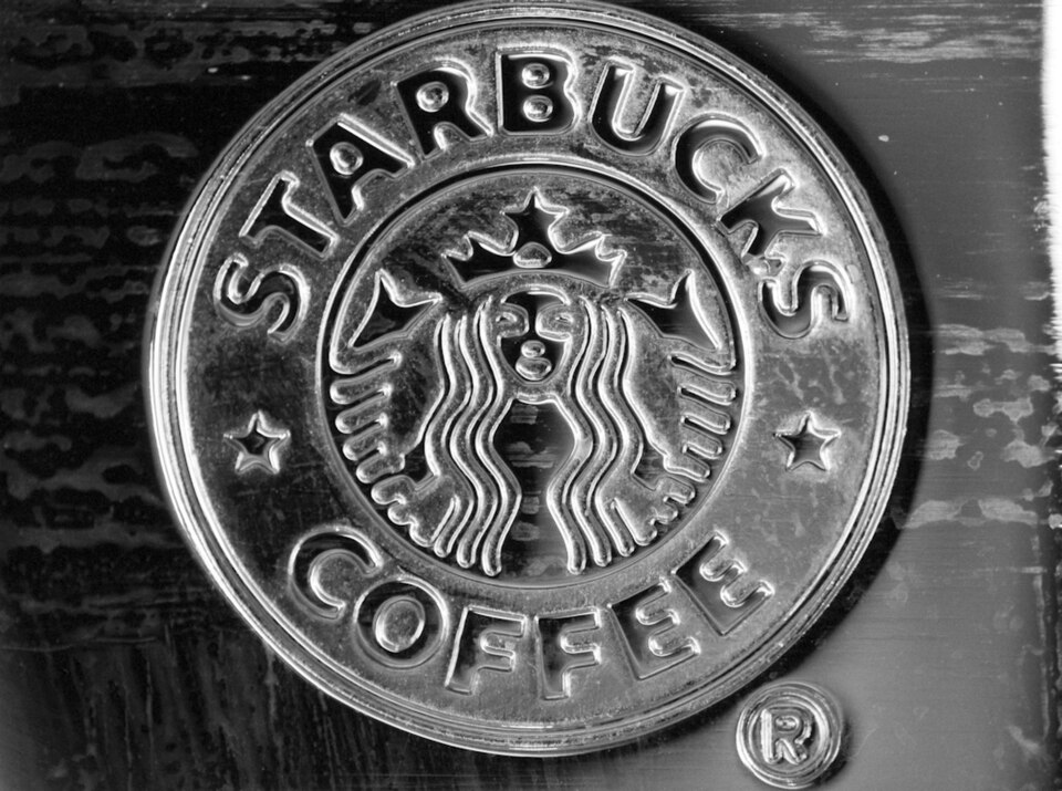The The Starbucks coffee chain logo — a crowned, twin-tailed siren figure inside a green disc